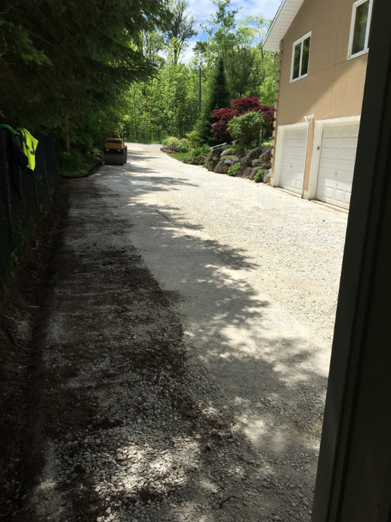 prepping driveway with gravel before paving with asphalt