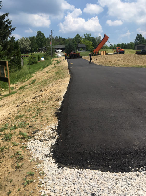 Asphalt driveway freshly paved at a residential property