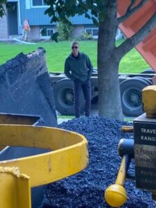 Sales man on the job for asphalt paving making sure everything is going well
